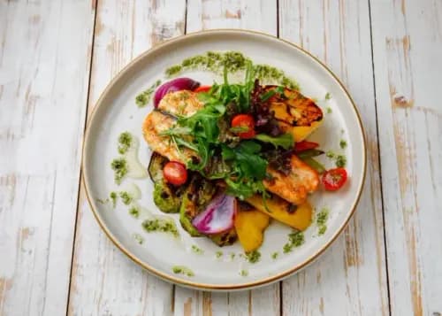 Grilled salmon with vegetables and pesto sauce
